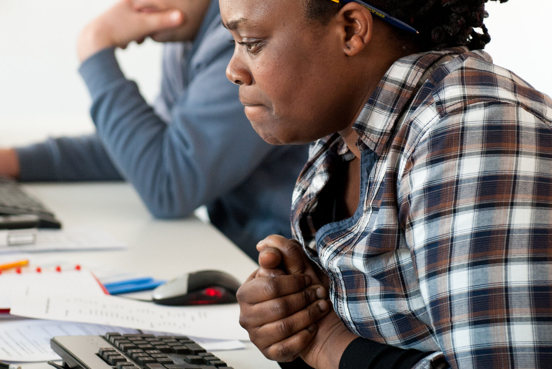vrouw aan een computer die geconcentreerd werkt