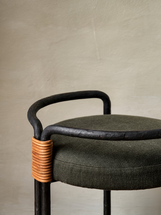 Leather connects the steel frame battered by hand upholstered in Belgian linen