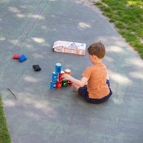 Kind speelt buiten met blokkentoren