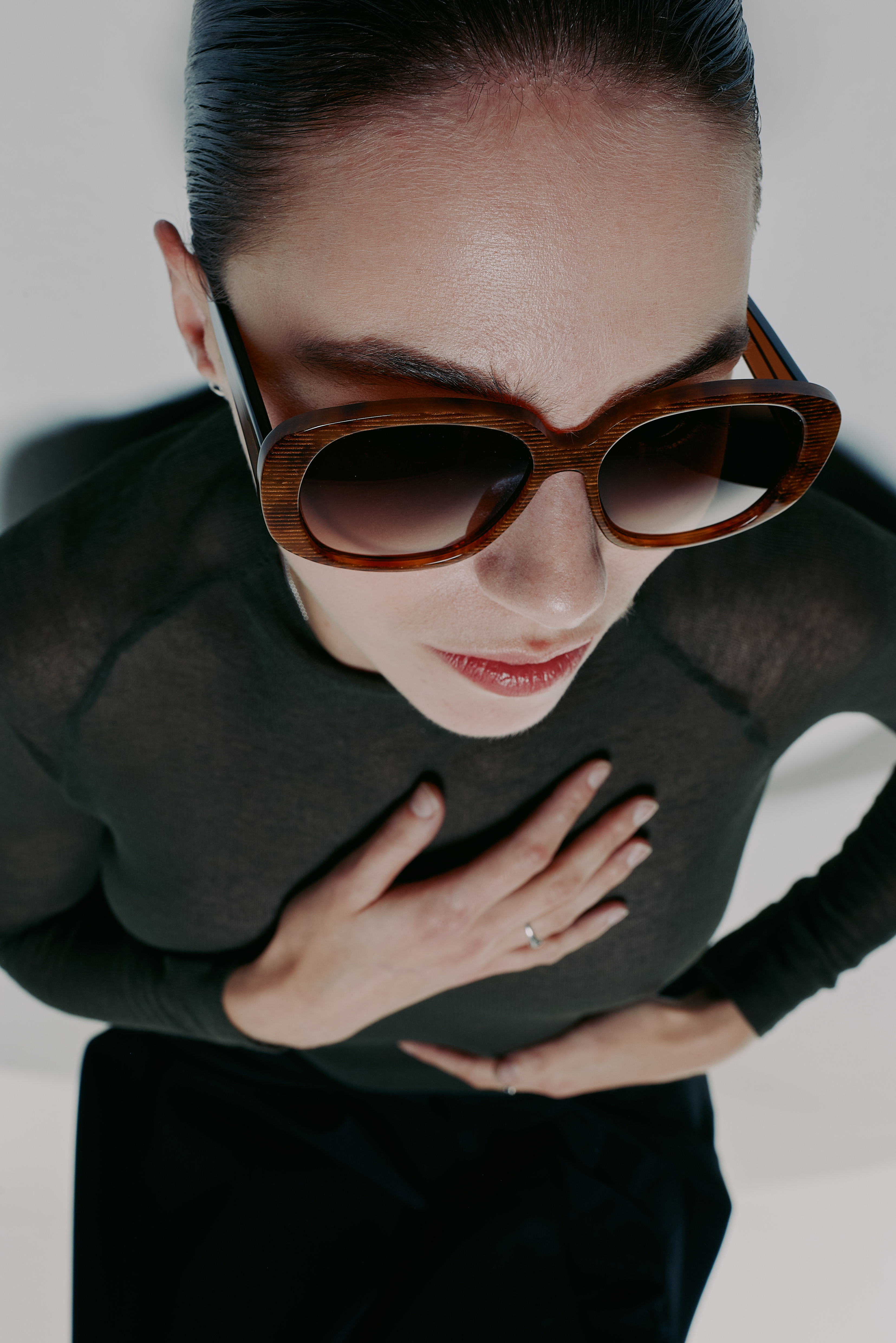 woman wearing striped sunglasses, laying down