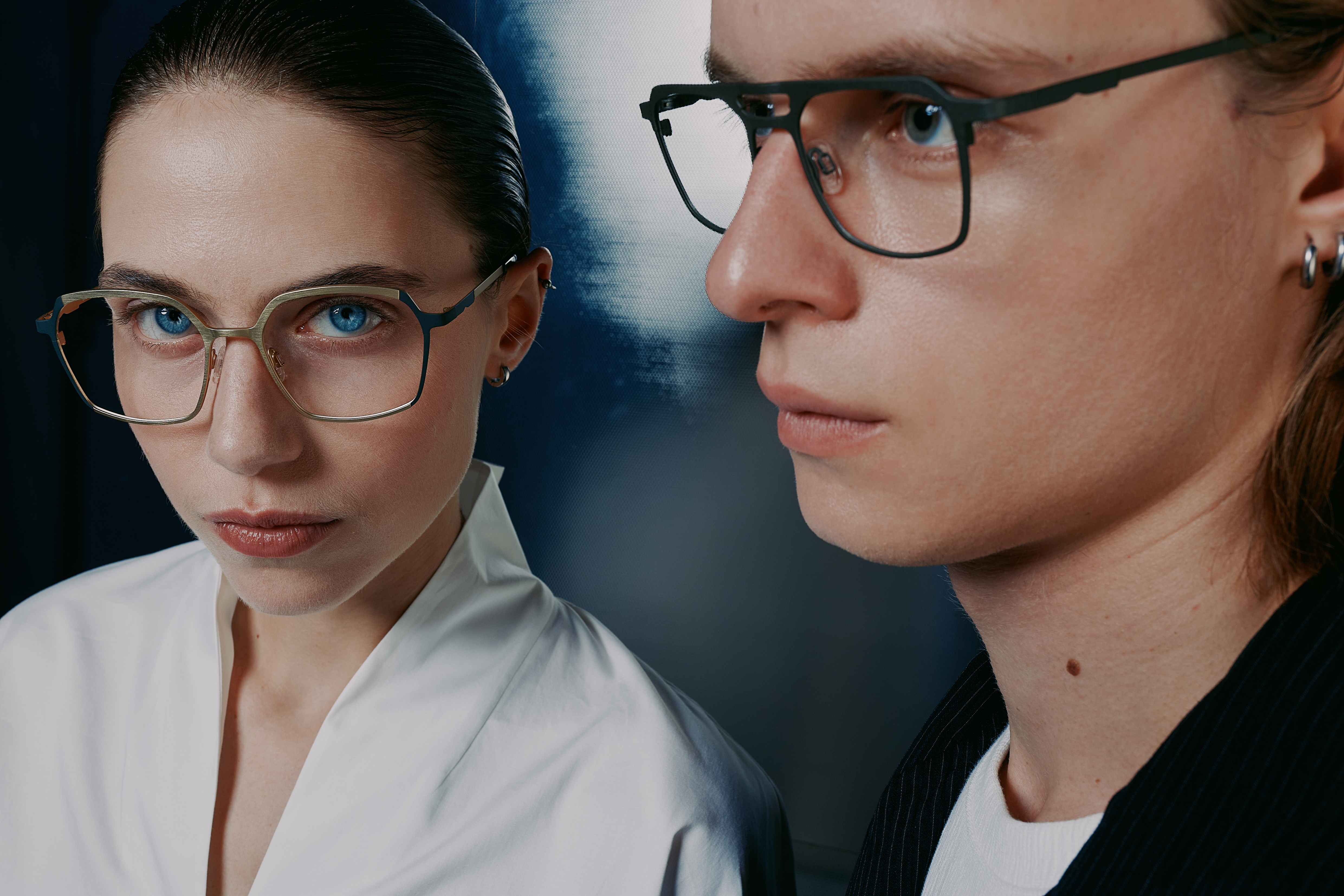man and woman wearing metal frames